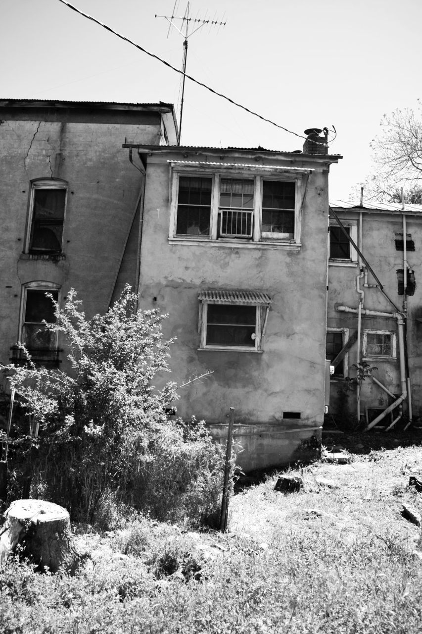 building exterior, architecture, built structure, building, residential district, house, day, no people, window, nature, plant, sky, abandoned, tree, outdoors, old, damaged, obsolete, run-down, weathered, ruined