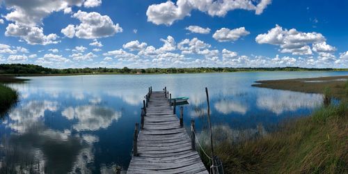 Panoramic view of pier over lake against sky