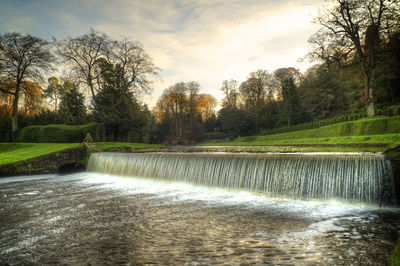 Fountain in park against sky
