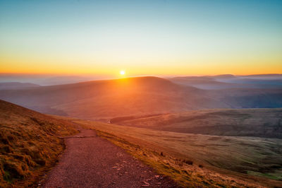 Scenic view of road against sky during sunset