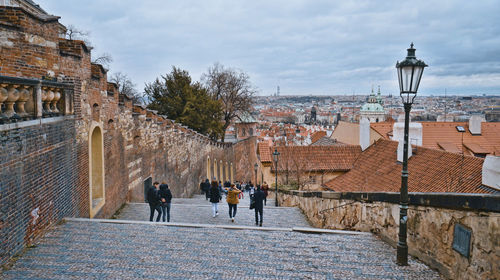 People walking on street amidst buildings in city