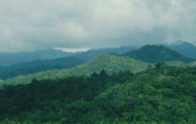 Scenic view of mountains against cloudy sky