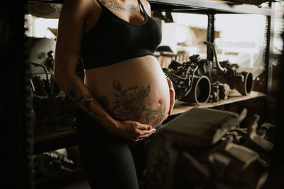 Midsection of woman standing at home