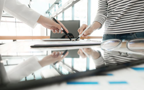 Midsection of females working in office