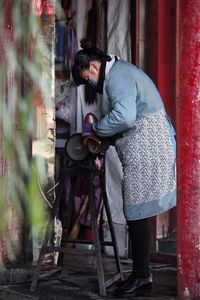 Woman making shoe at workshop