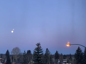 Elevated view of illuminated street light against bright night sky.