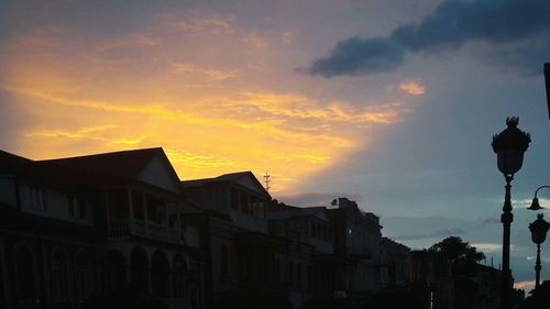 Low angle view of silhouette buildings against sky during sunset