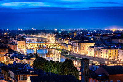 High angle view of illuminated buildings in city at night