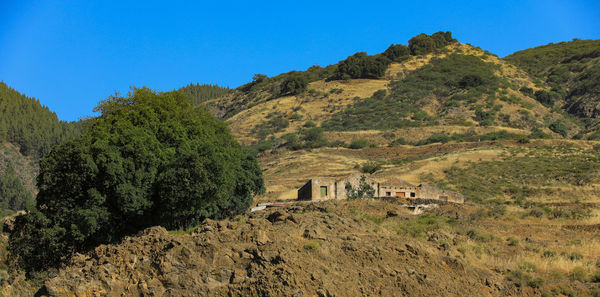 Scenic view of mountains against clear blue sky