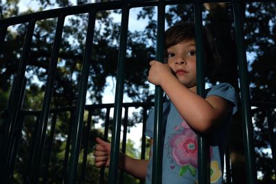 Girl standing by railing