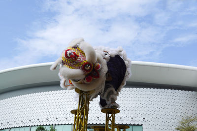 Low angle view of tiger against sky