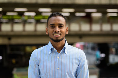 Portrait of young man standing outdoors