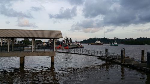 Pier on lake against sky