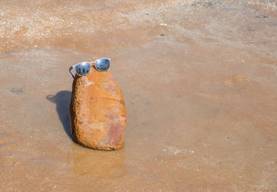 High angle view of abandoned bottle on beach