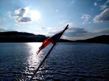 Red flag on mountain against sky