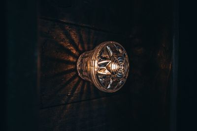 Close-up of illuminated lighting equipment attached on wall