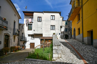 A narrow street between the old houses of petina, a village of salerno province, italy.