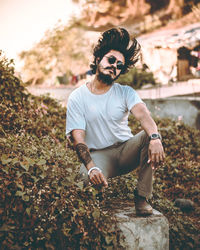 Full length portrait of young man standing on land