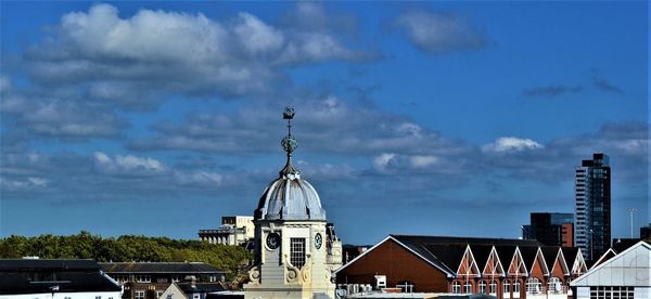 Panoramic view of buildings in city against sky