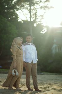 Full length portrait of young couple outdoors