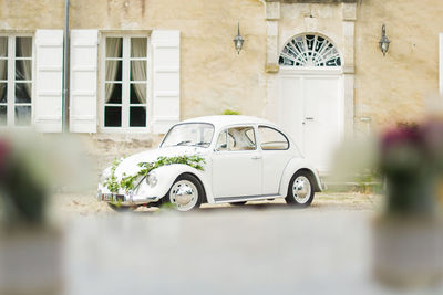 Vintage car on street against building