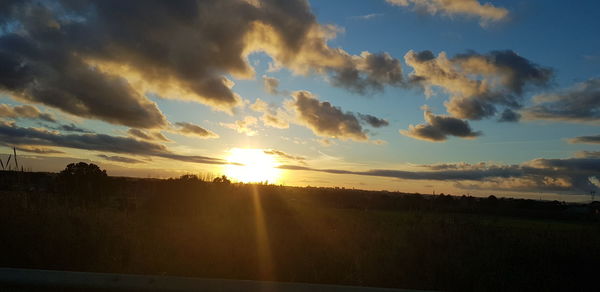 Silhouette landscape against sky during sunset