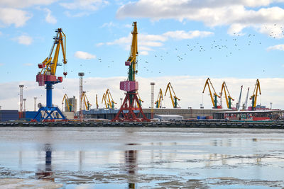 Massive harbor cranes in seaport. heavy load dockside cranes in port, cargo container ship terminal