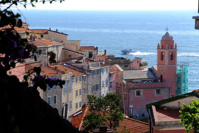 High angle view of buildings by sea against sky