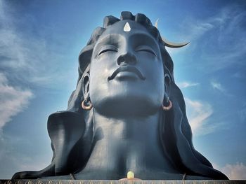 Low angle view of religious statue against sky