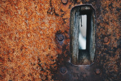 Close-up of rusty metal with hole