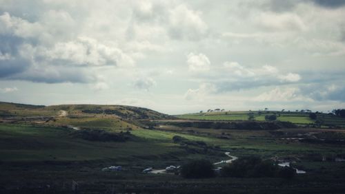 Scenic view of agricultural landscape against sky