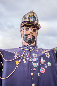 Close-up portrait of man standing against sky