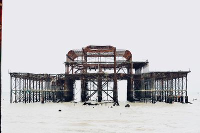 Built structure on beach against clear sky