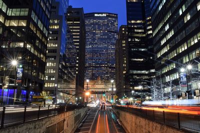 Illuminated city street at night