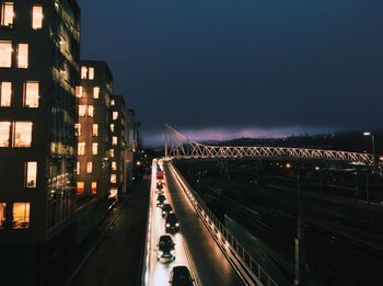 Illuminated suspension bridge in city at night