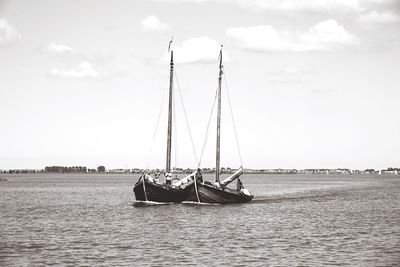 Sailboat in sea against sky