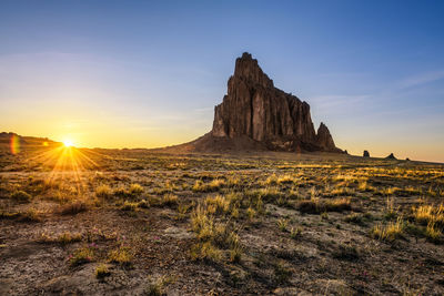 Scenic view of rock formation against sky during sunset