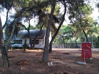 House on field against trees