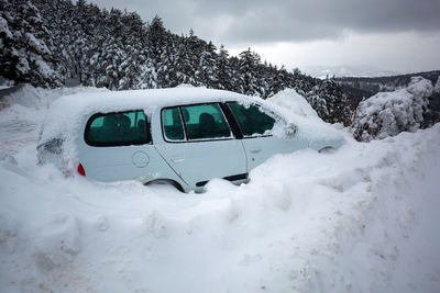 Car stuck in deep snow on mountain road - winter traffic problem stock image