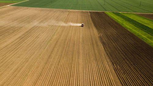 Aerial view of agricultural machinery working in field