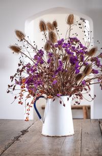 Close-up of flower vase on table at home