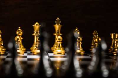 Illuminated chess pieces against black background