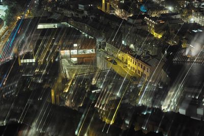 Aerial view of illuminated city buildings at night