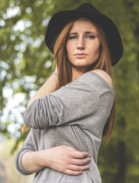 Portrait of young woman with long hair wearing hat