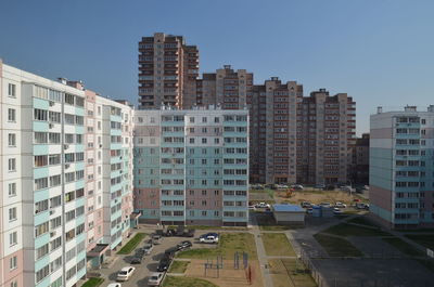 Buildings in city against clear sky