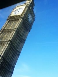 Low angle view of tower against blue sky