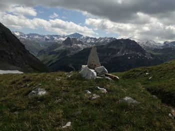 View of a horse on landscape against cloudy sky