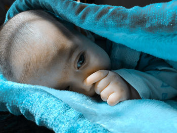 Close-up portrait of cute baby lying down