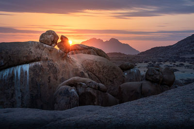 Scenic view of rocks against sky during sunset