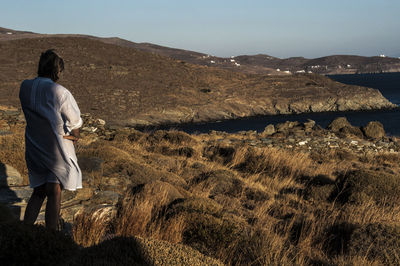 Rear view of man standing on landscape